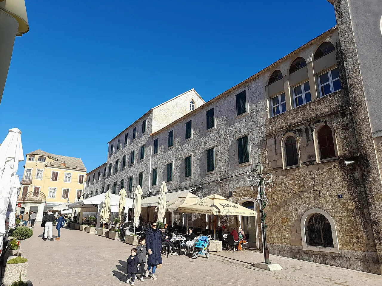 Café terraces on a street in Sinj.