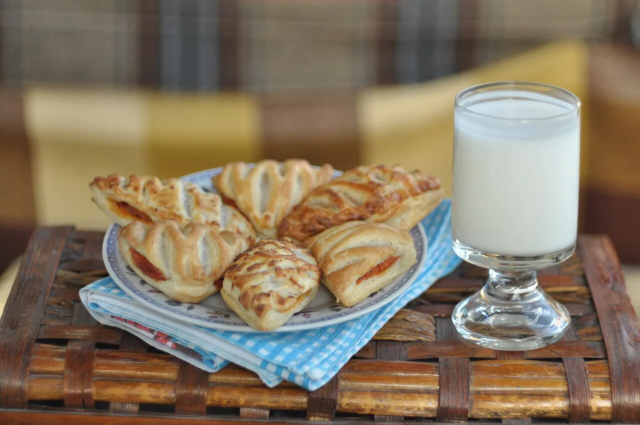 Puff pastries served with a glass of yoghurt.