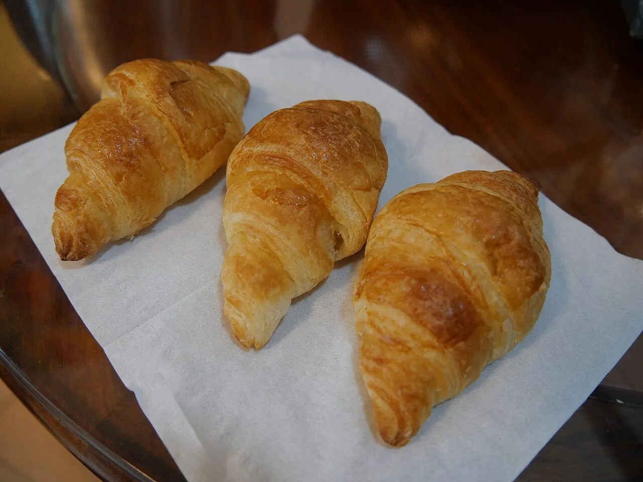 Freshly baked croissants on a paper napkin.