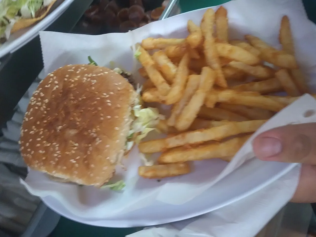A burger served with fries.