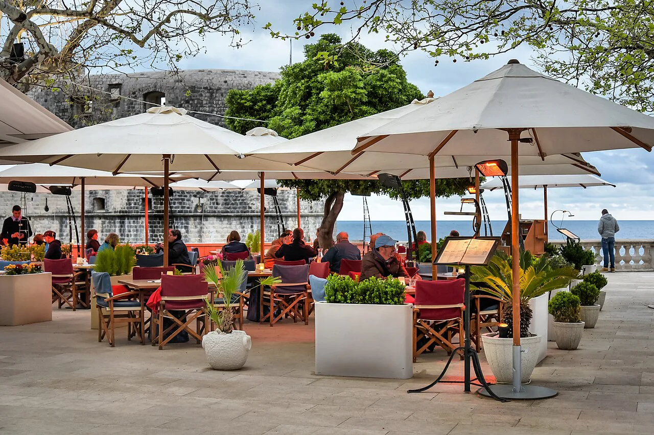 Restaurant terraces under white umbrellas, Dubrovnik.