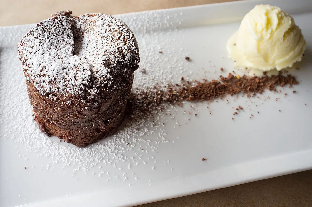 Chocolate cake served with a scoop of ice cream.