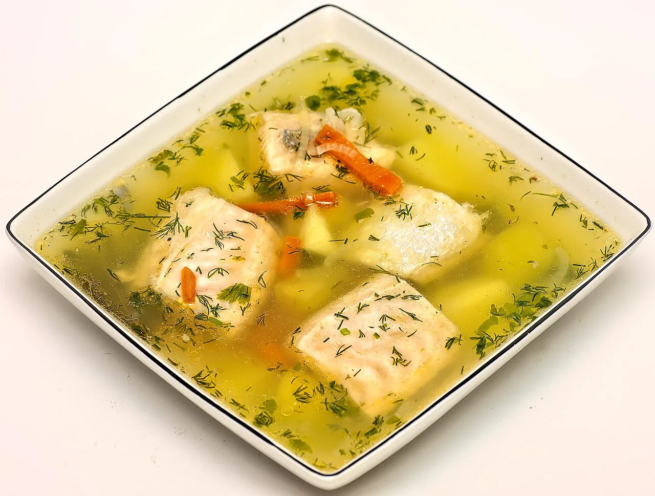 Clear fish soup with herbs.