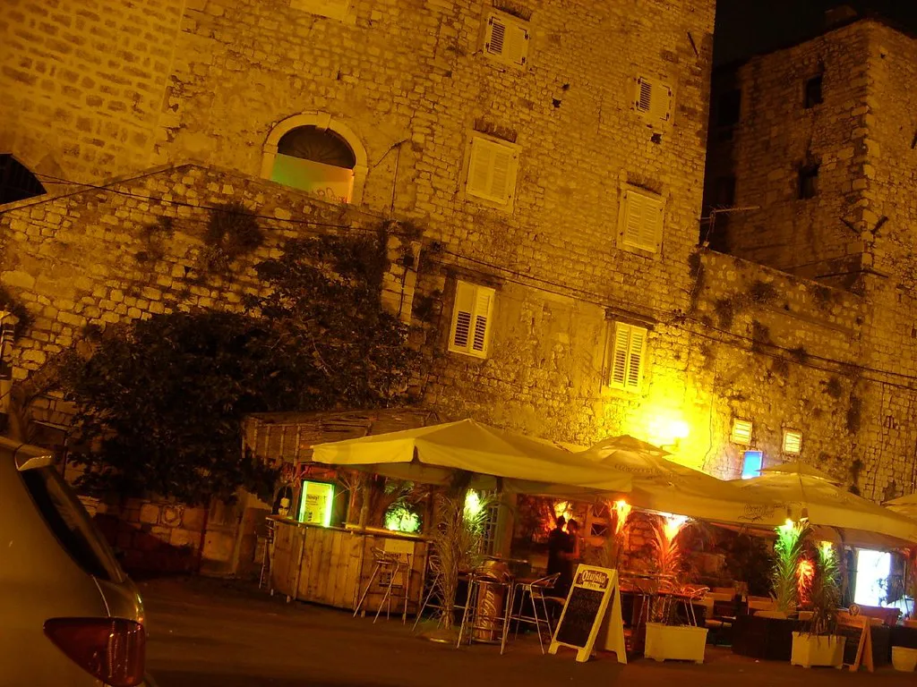 A café terrace in Šibenik's old town at night.