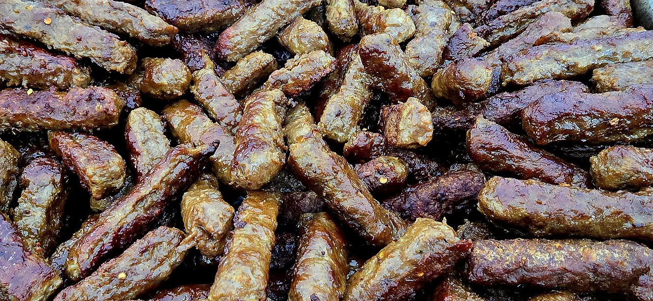 Grilled ćevapčići at a street-festival stall.