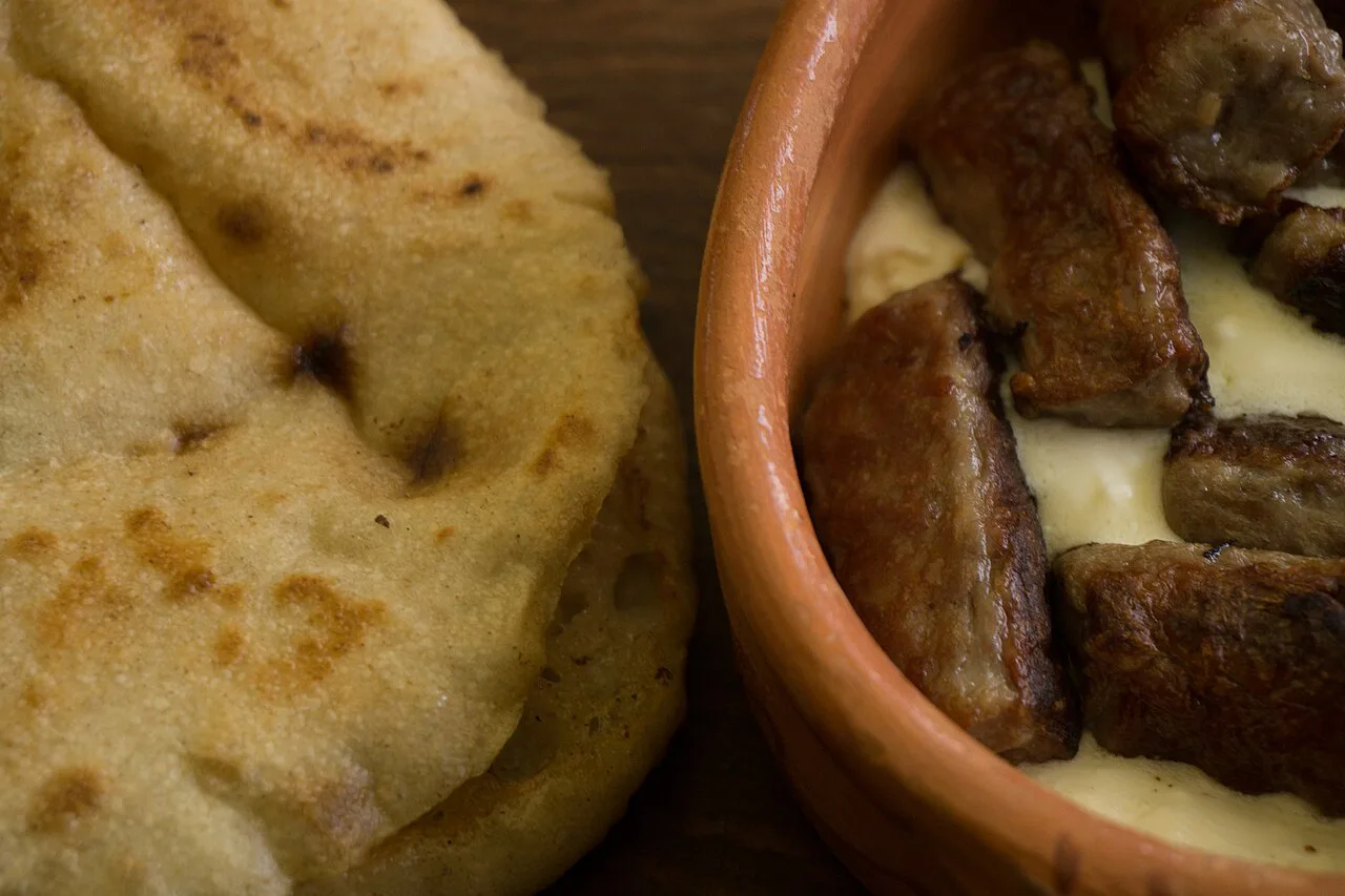 Ćevapi with lepinja flatbread and kajmak.