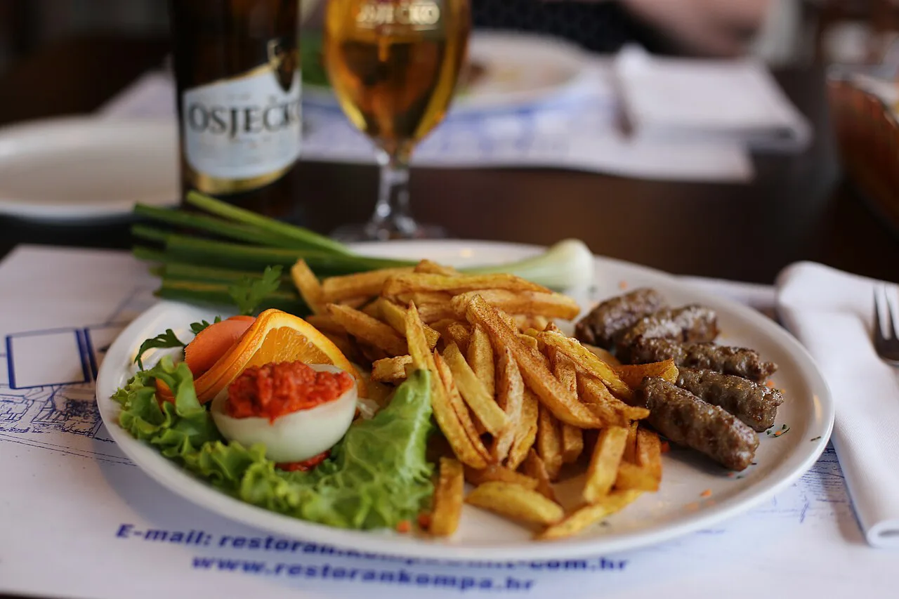 Ćevapi with chips and salad at Restoran Kompa.
