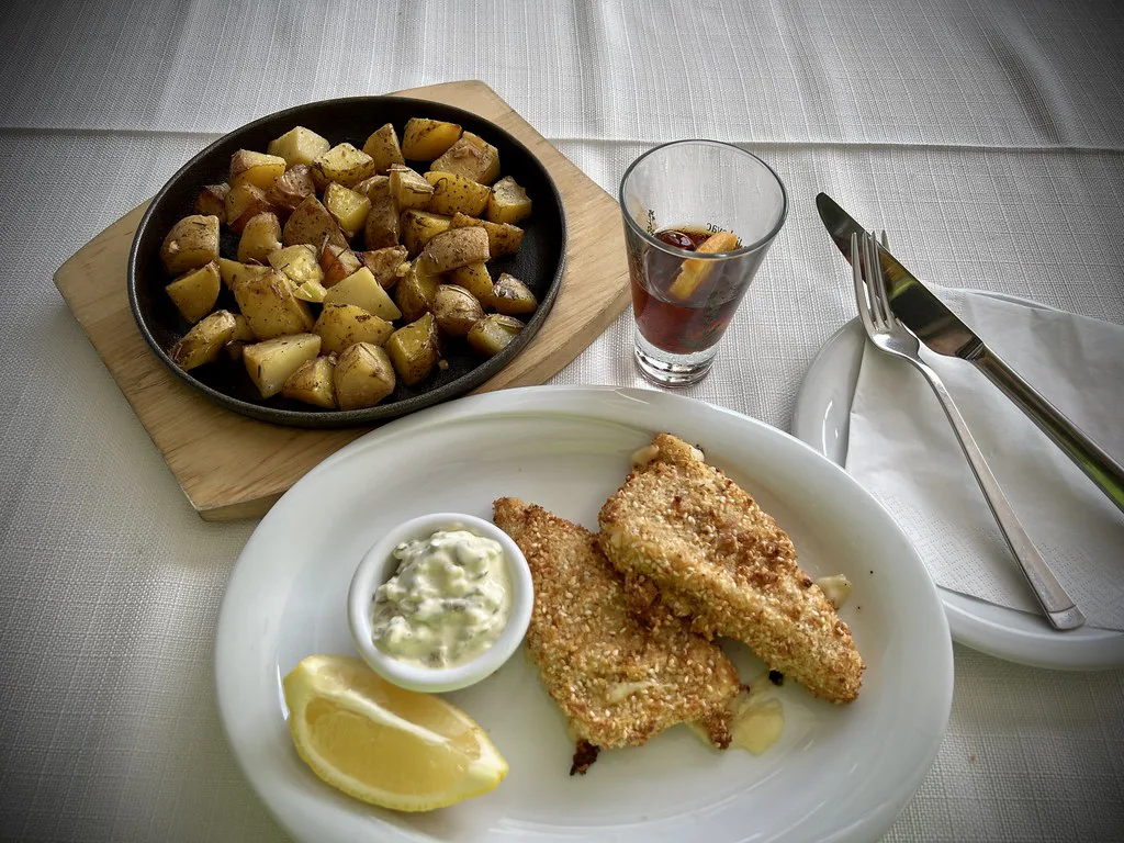 A glass of Pelinkovac herbal liqueur served with lunch.