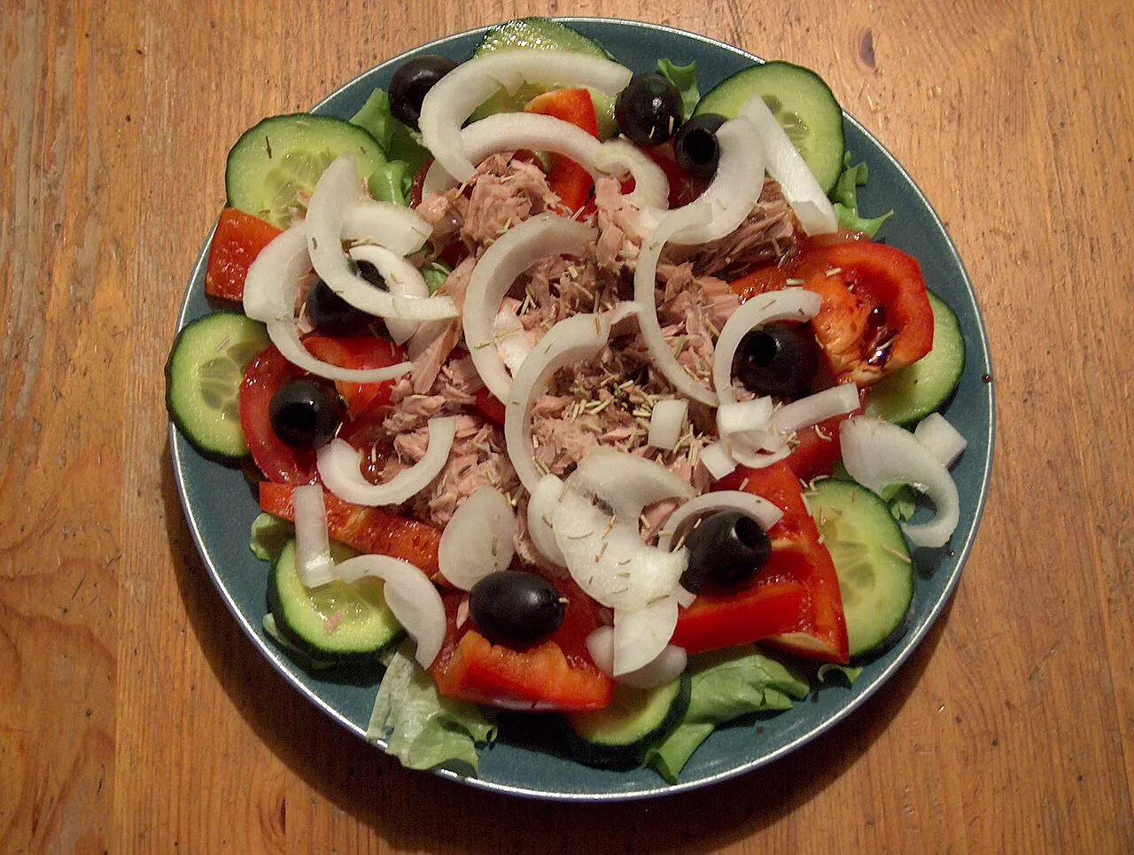 Tuna salad with tomato, cucumber, onion and olives.