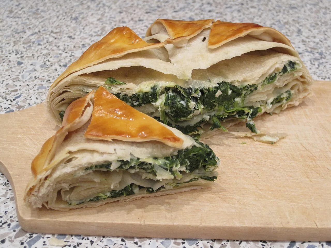 Spinach burek cut into pieces.
