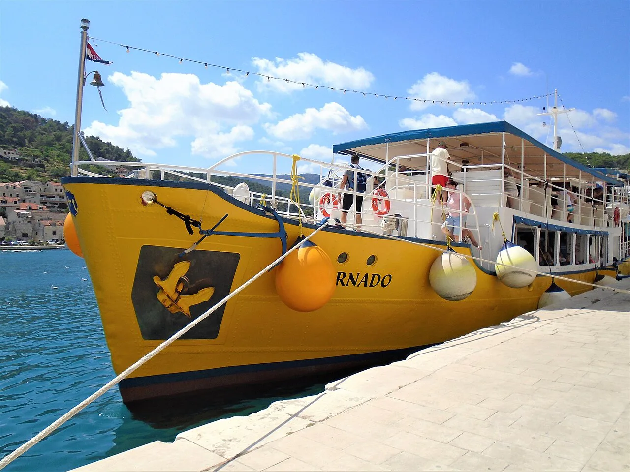A yellow excursion boat in Pučišća harbour, Brač.