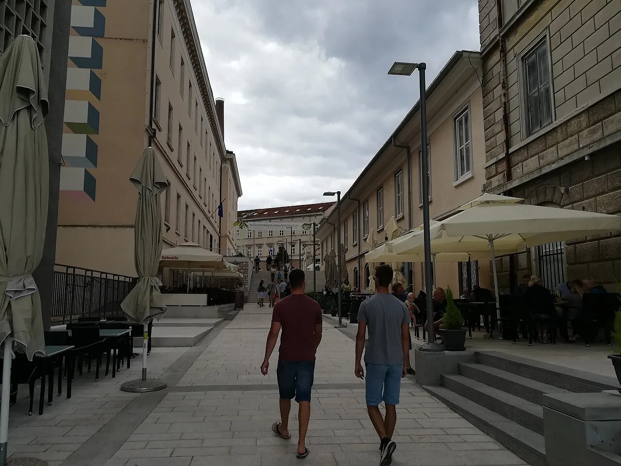 Café umbrellas on a street in Pula.