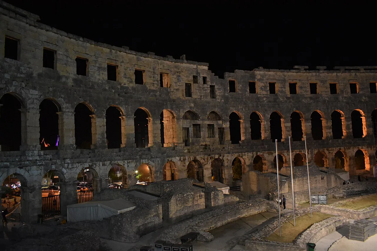 The Pula Arena lit up at night.