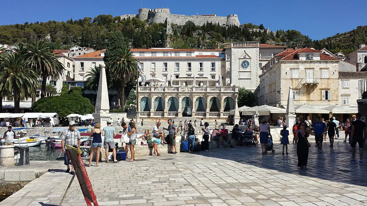 Hvar town's main square with the fortress above.
