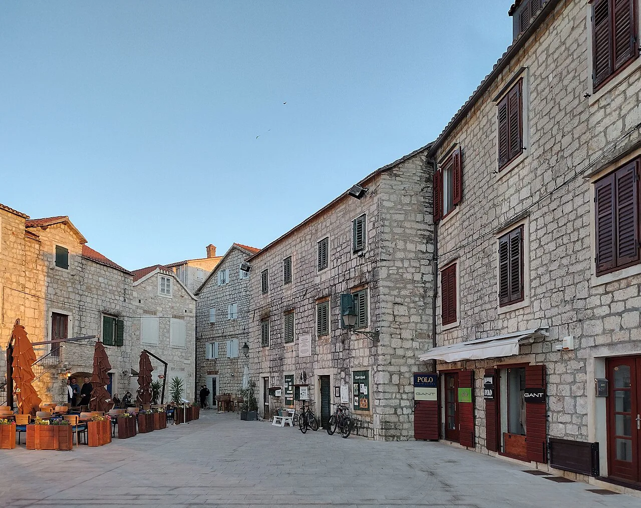 A stone street with café tables in Stari Grad, Hvar.