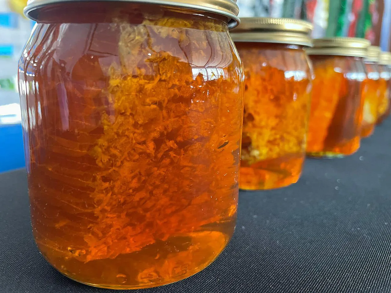 Jars of honey with honeycomb.