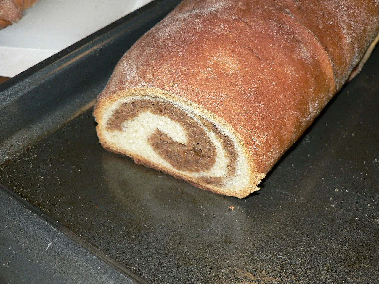 A freshly baked walnut roll, cut open.
