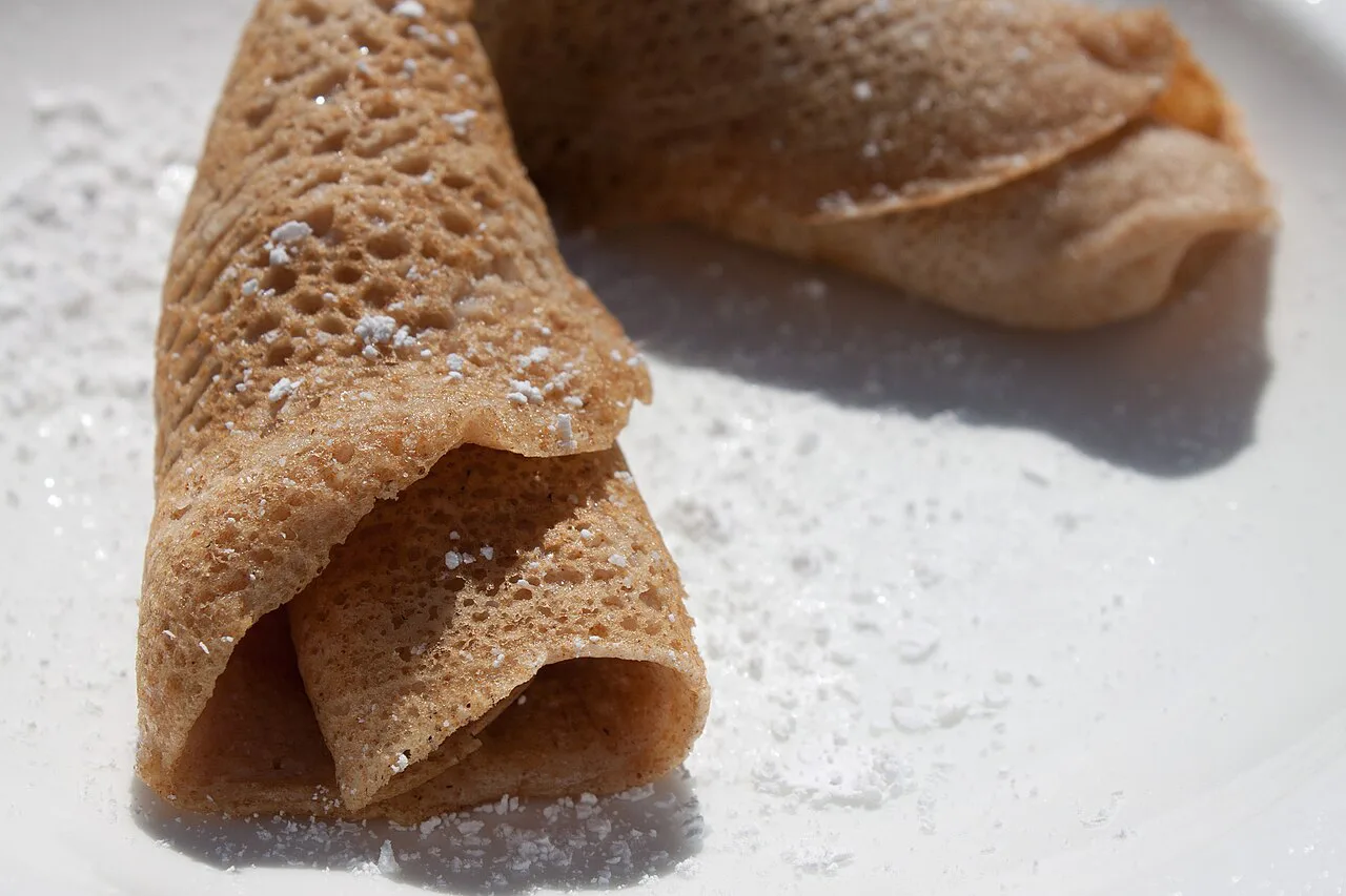 A thin rolled pancake dusted with sugar.