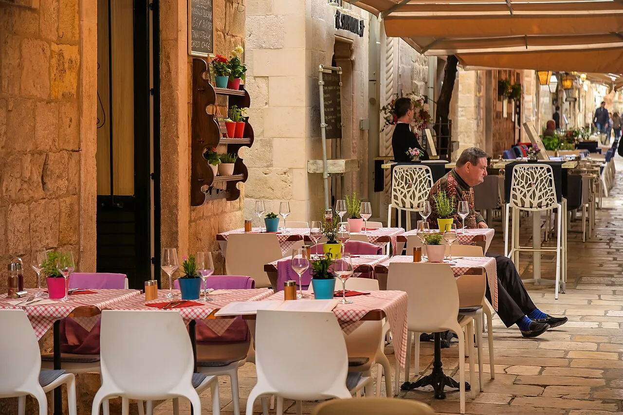 Restaurant tables in an old-town lane, Dubrovnik.