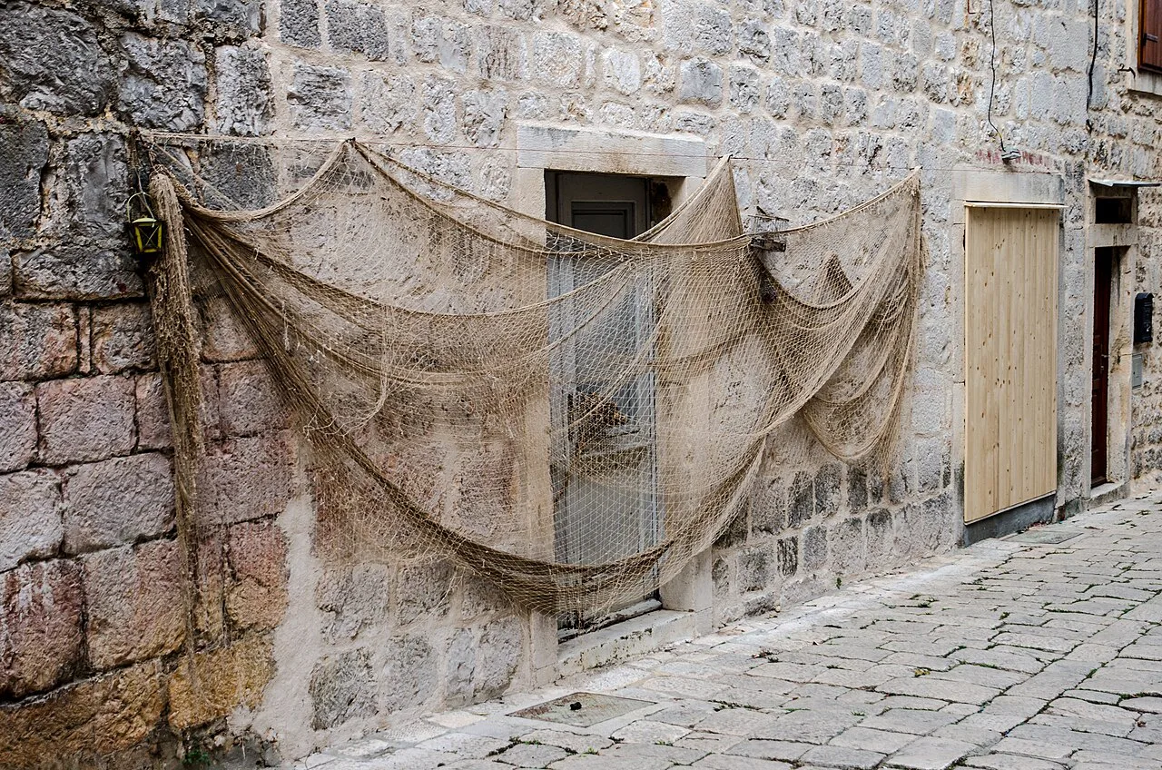 Fishing nets hung on a stone wall in Stari Grad, Hvar.