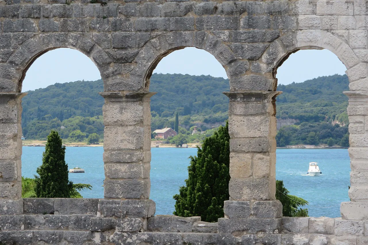 The sea seen through the arches of the Pula Arena.