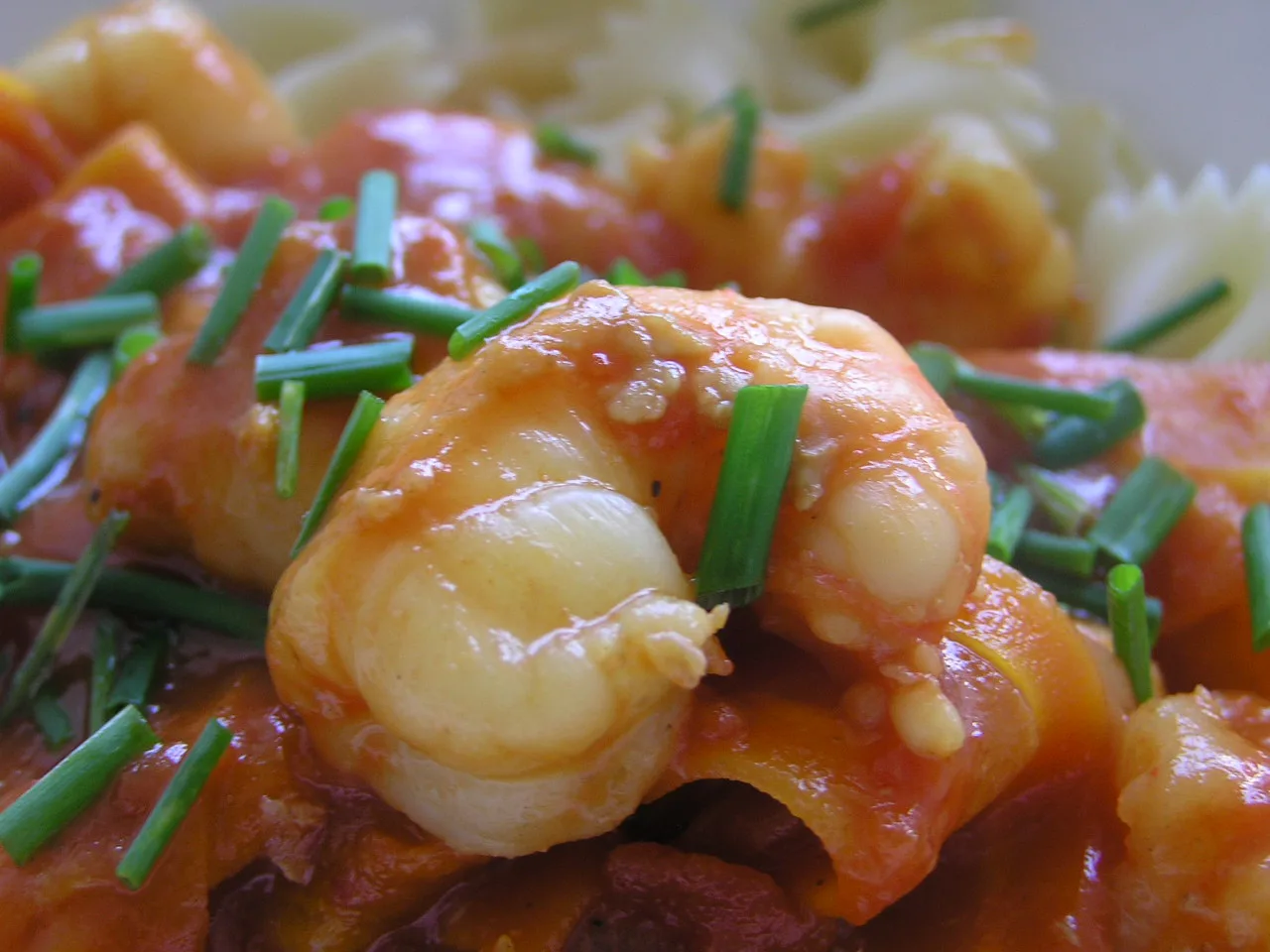 Scampi in a tomato sauce with chives.