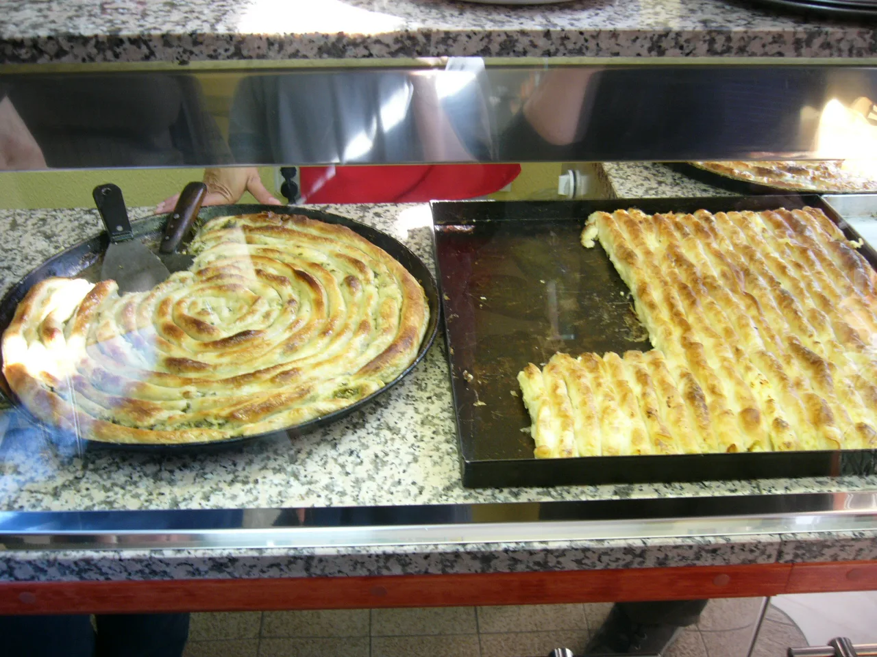 Trays of zeljanica and sirnica pastry.