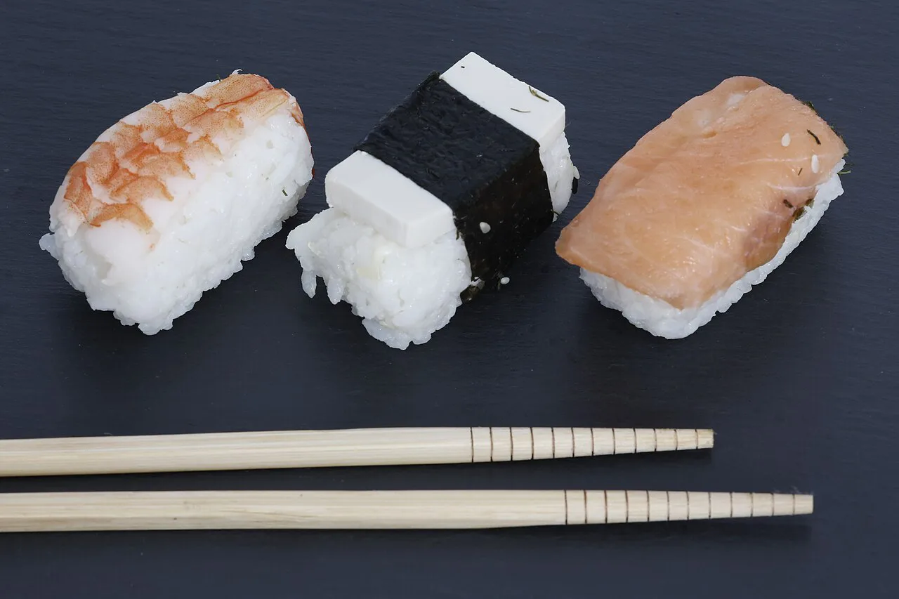 Nigiri sushi with chopsticks.