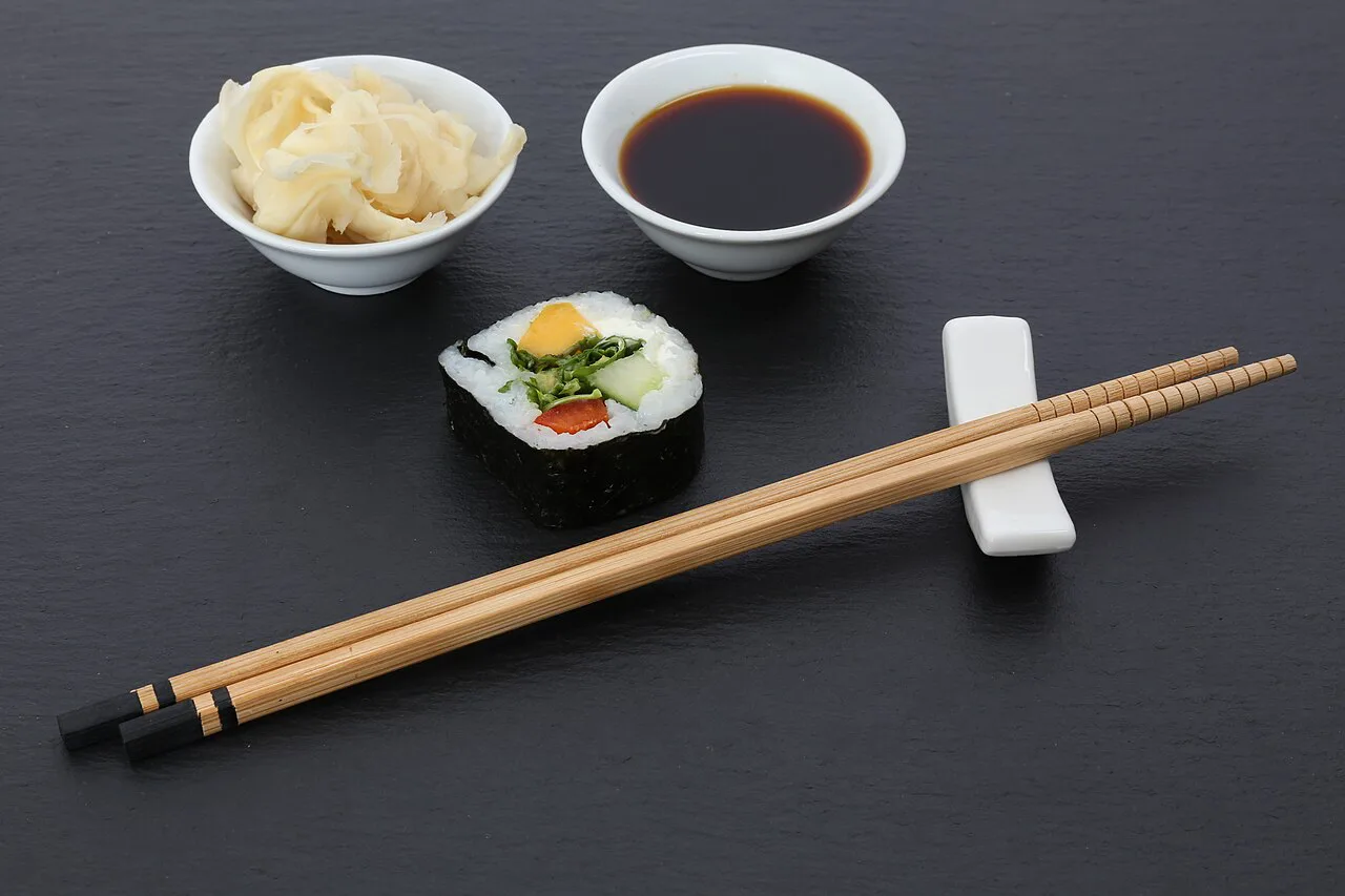 Sushi with soy sauce and pickled ginger.