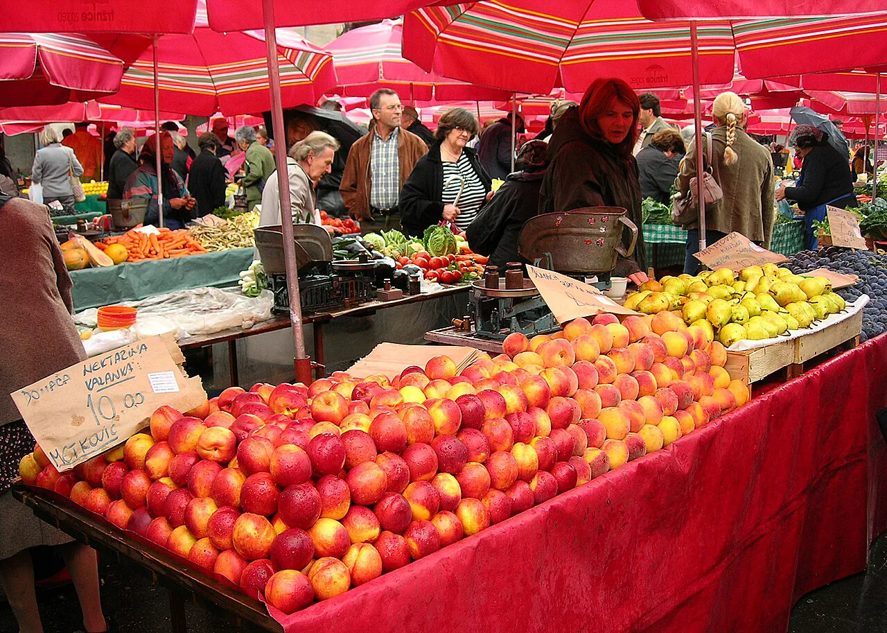 Fruit stalls under red umbrellas at Dolac market, Zagreb.