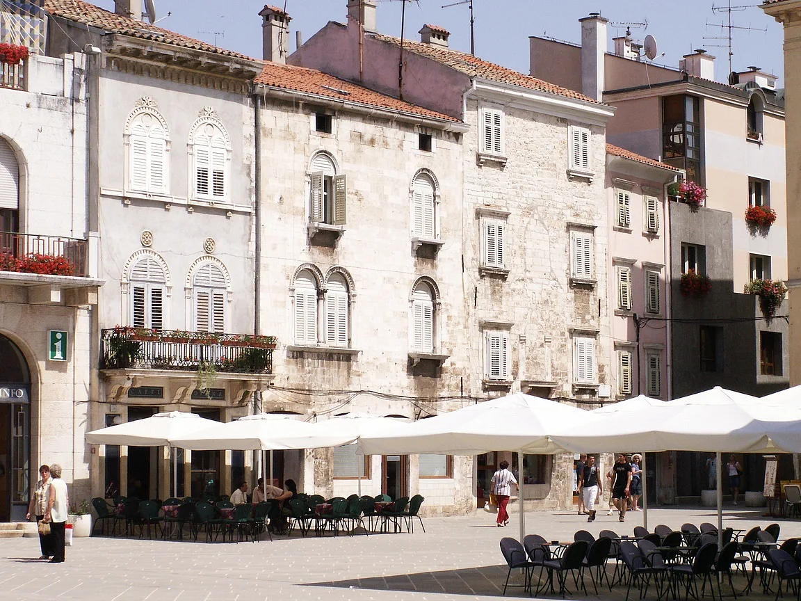 Café terraces on a street in Pula.