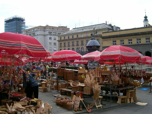Stalls under red umbrellas at Dolac market, Zagreb.